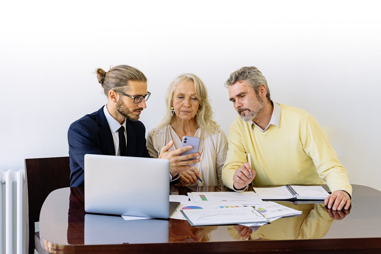 A bank manager discussing fixed vs variable loan rates with an older couple