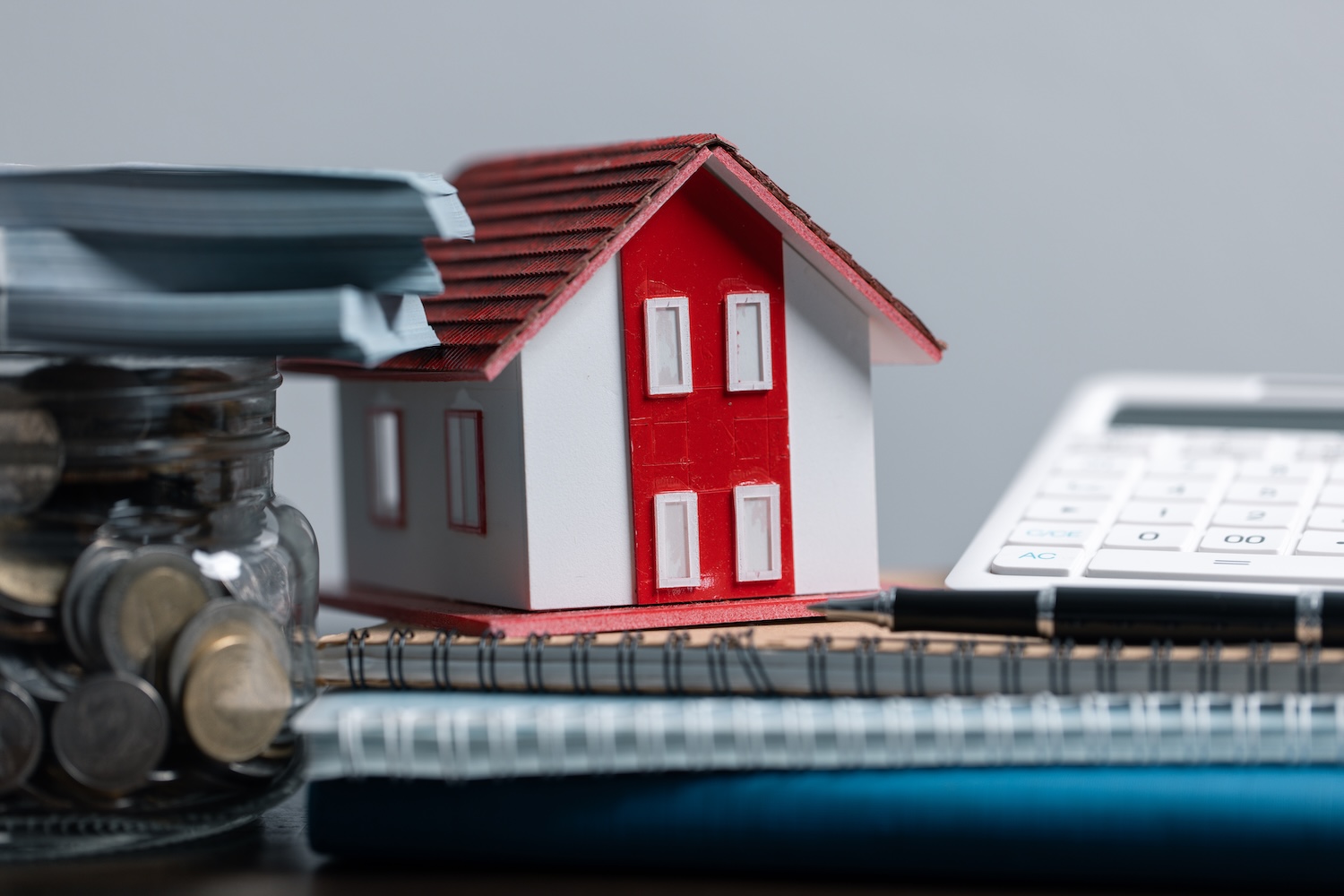A house on a pile of paperwork showing how to get a personal loan without collateral