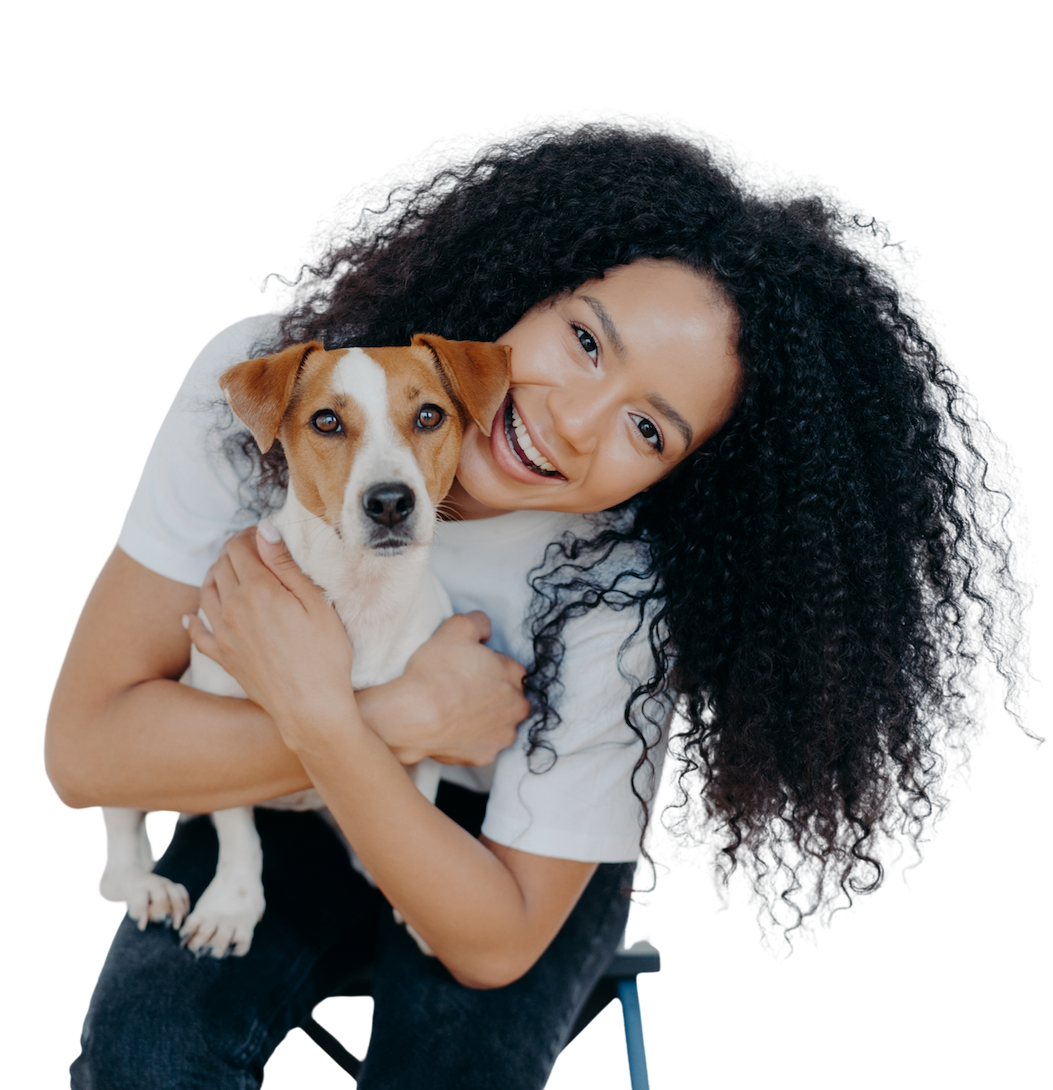 A woman holding her dog, celebrating she found veterinary financing