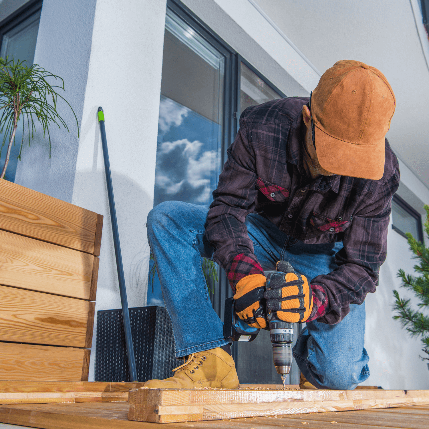 A man using power tools to renovate a deck
