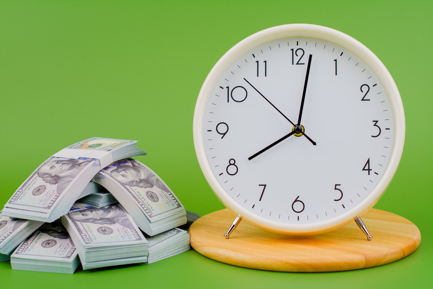 A pile of dollars and a clock to represent ‘How Long Does a Personal Loan Take to Process?’