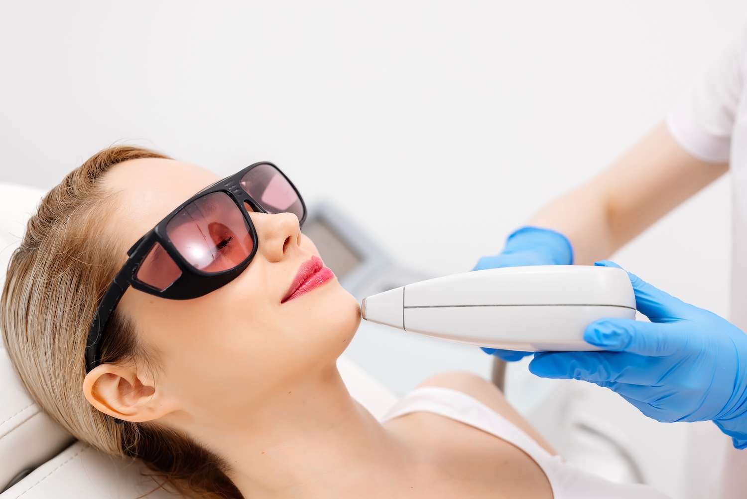 A woman having a laser treatment to her face, which she paid for with cosmetic surgery financing