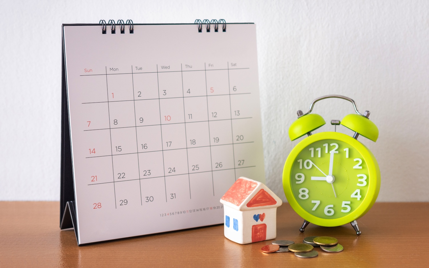 Calendar and house on table for the question 'how long can you take out a personal loan for'