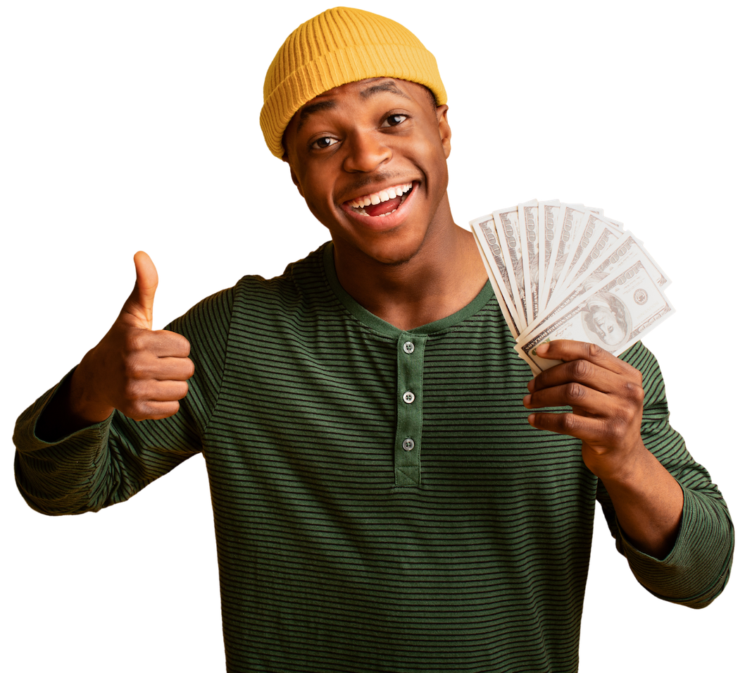 A black man holding dollars and smiling with a thumbs up because he got personal loans in kansas