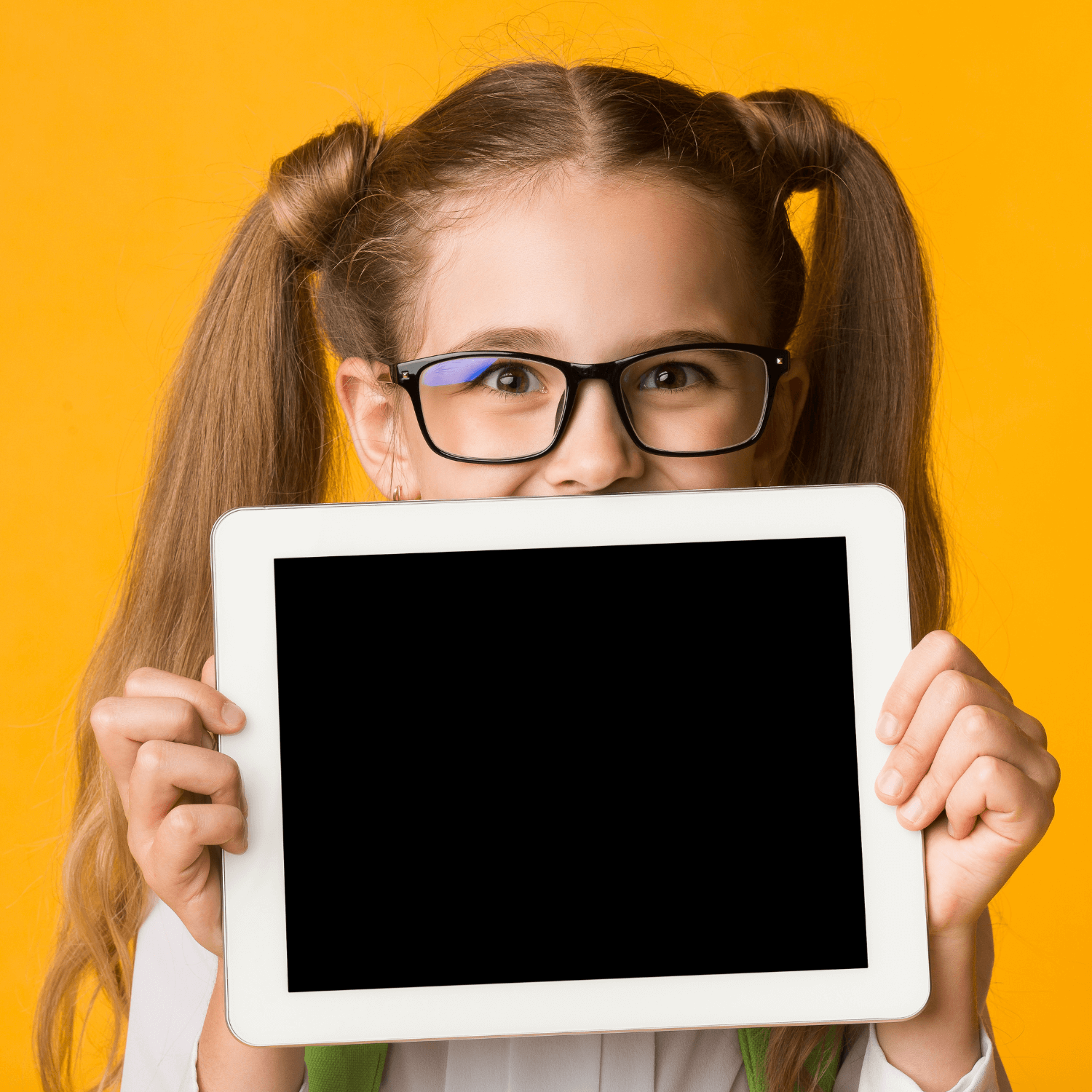 A child holding up a tablet to represent back to school loans