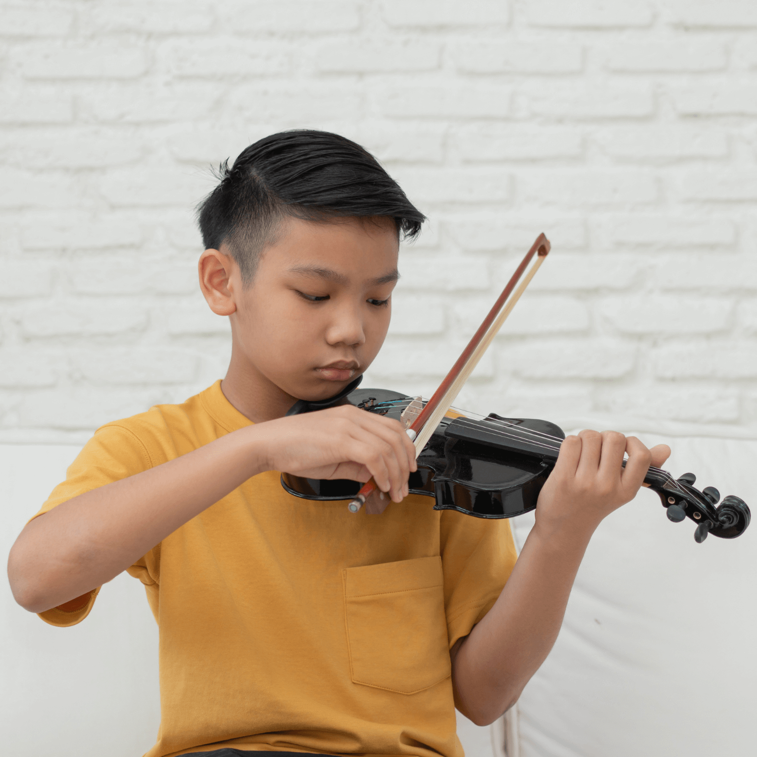 A child playing a violin to represent back to school loans