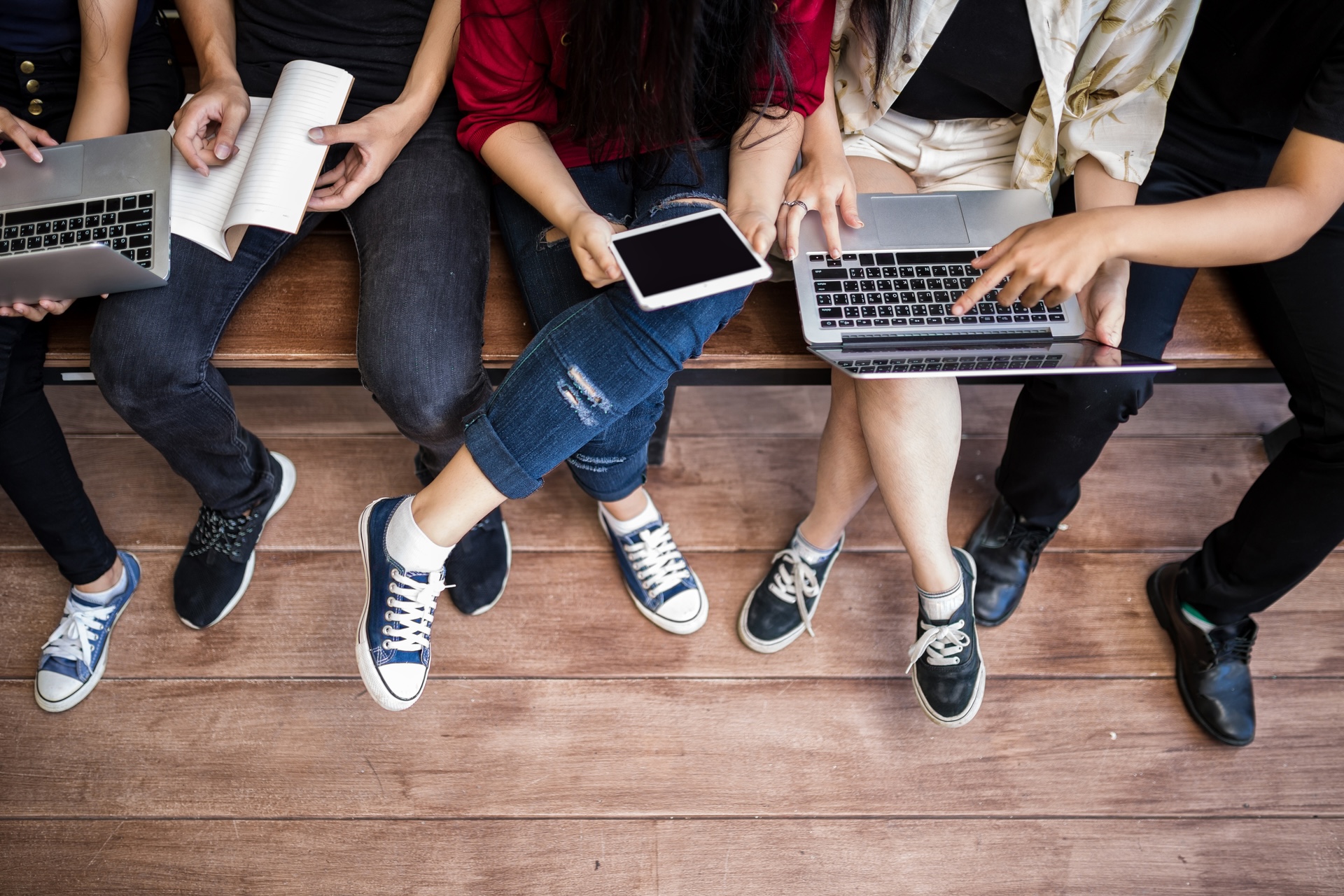 Students sat on laptops and tablets to represent  'back to school loans'.