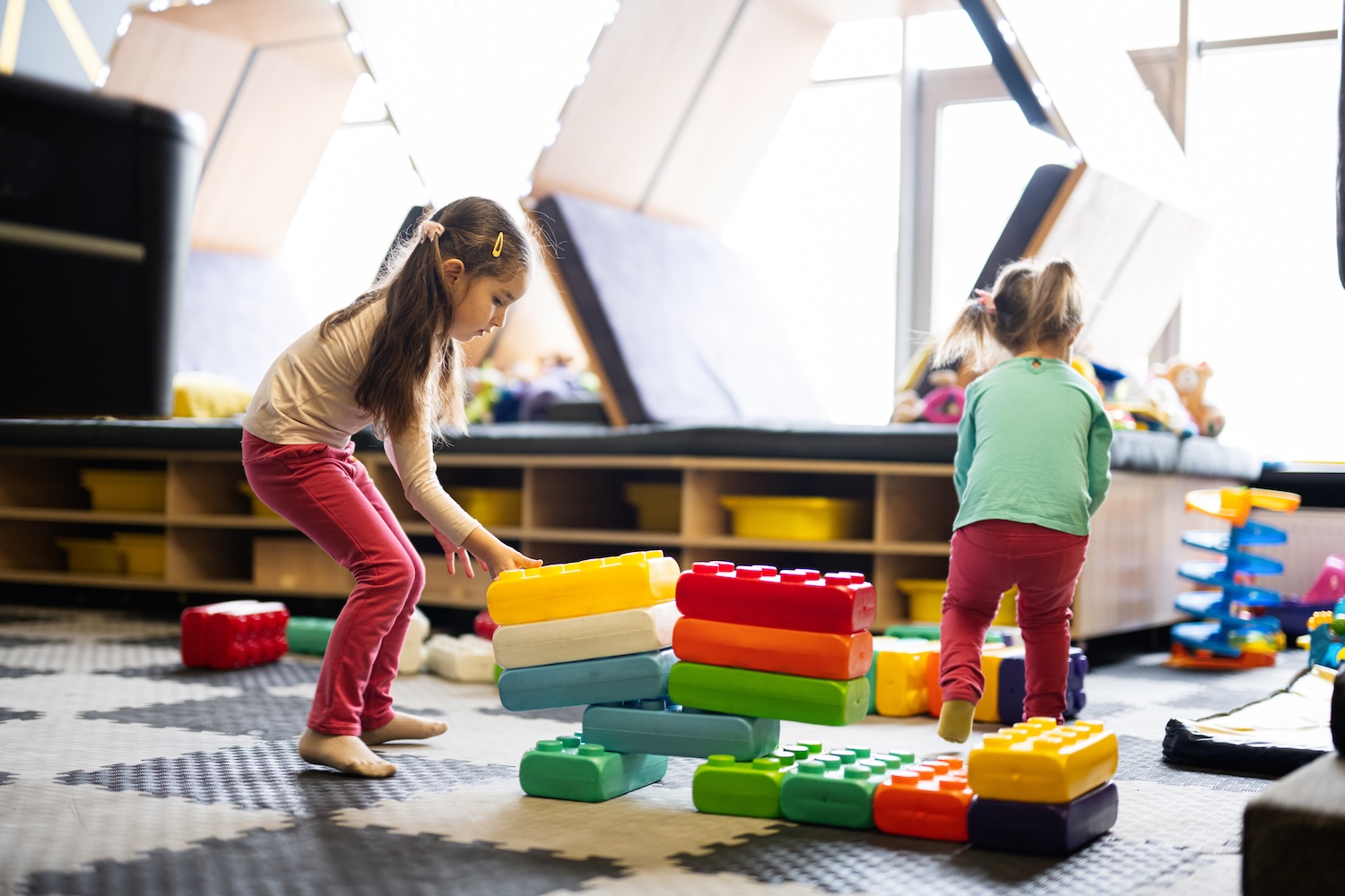Children playing at a daycare because their parents got a childcare loan