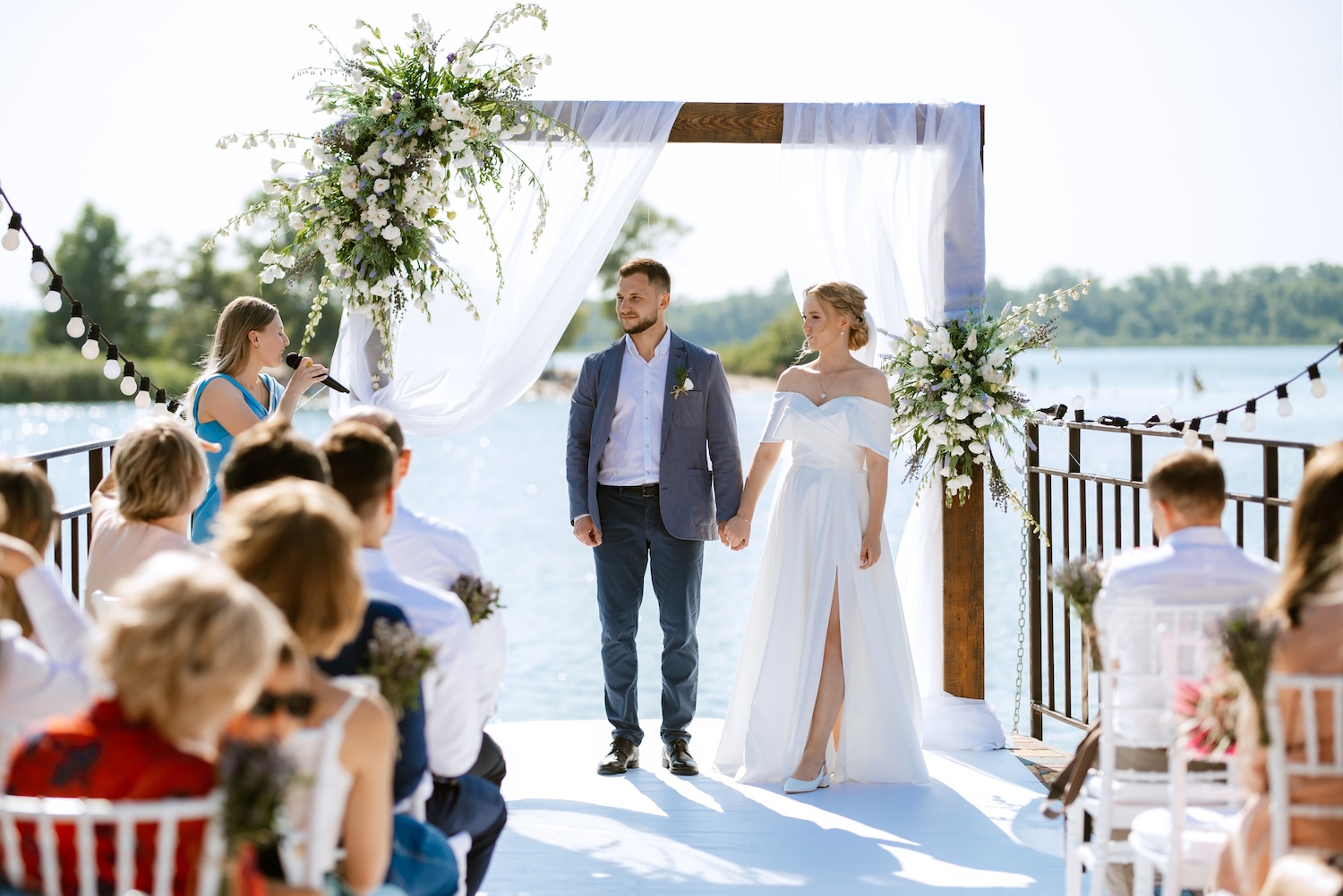 A wedding ceremony taking place on a pier to represent destination wedding loans