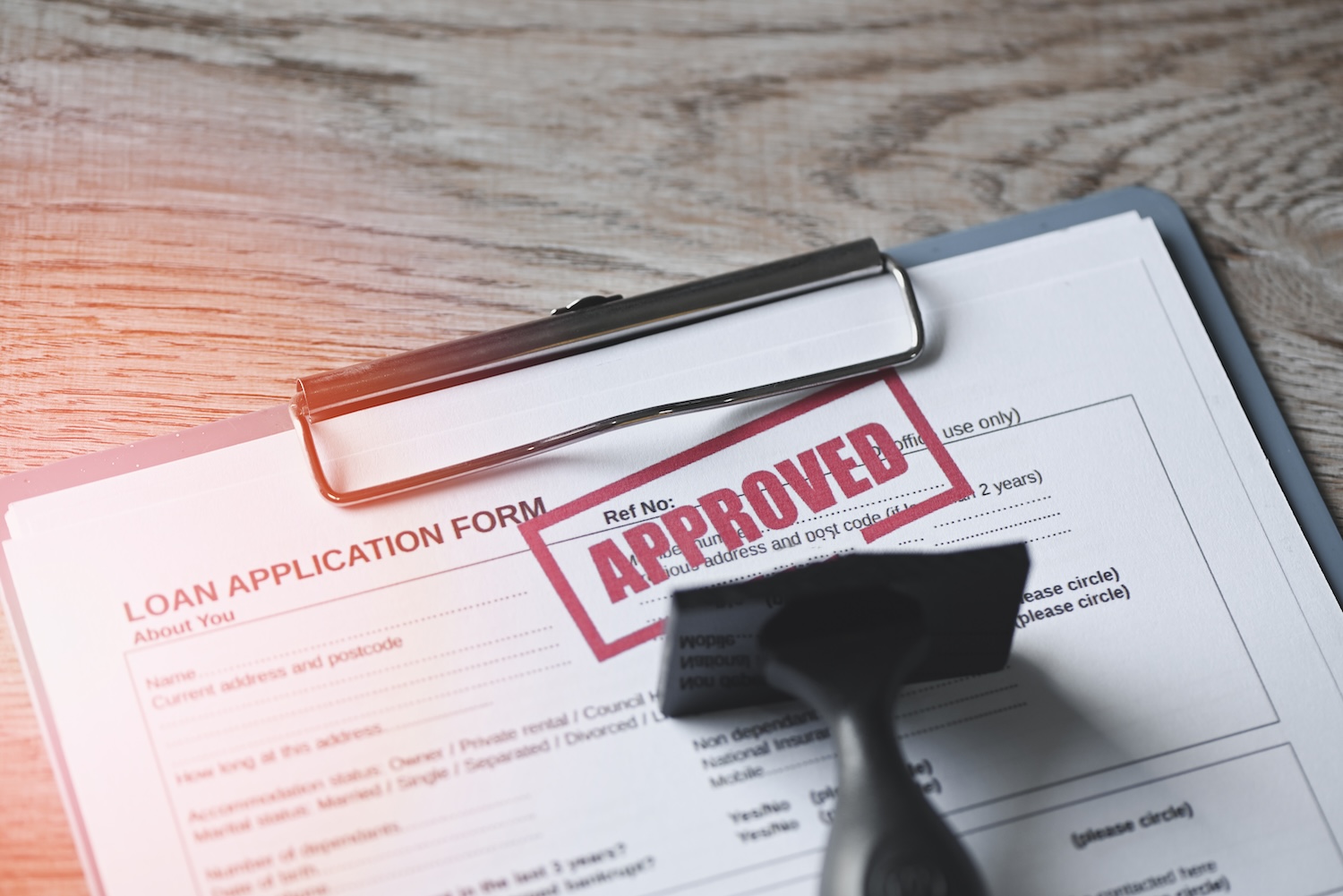 A loan application that has been stamped approved, after they learned how to apply for an installment loan